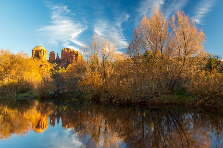 Cathedral Rock reflecting off the water on a sunny day.